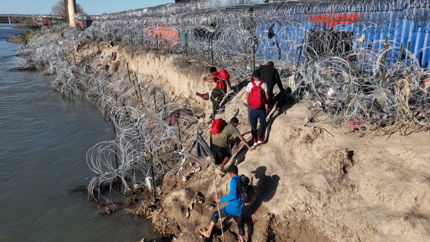 EAGLE PASS, TEXAS – FEBRUARY 03: An aerial view shows an immigrant group trying to cross the Texan border despite heightened security measures in Eagle Pass, Texas on February 03, 2024. Border Patrol moved migrants away from the Eagle Pass border of US-Mexico as a precautionary measure. (Photo by Lokman Vural Elibol/Anadolu via Getty Images)